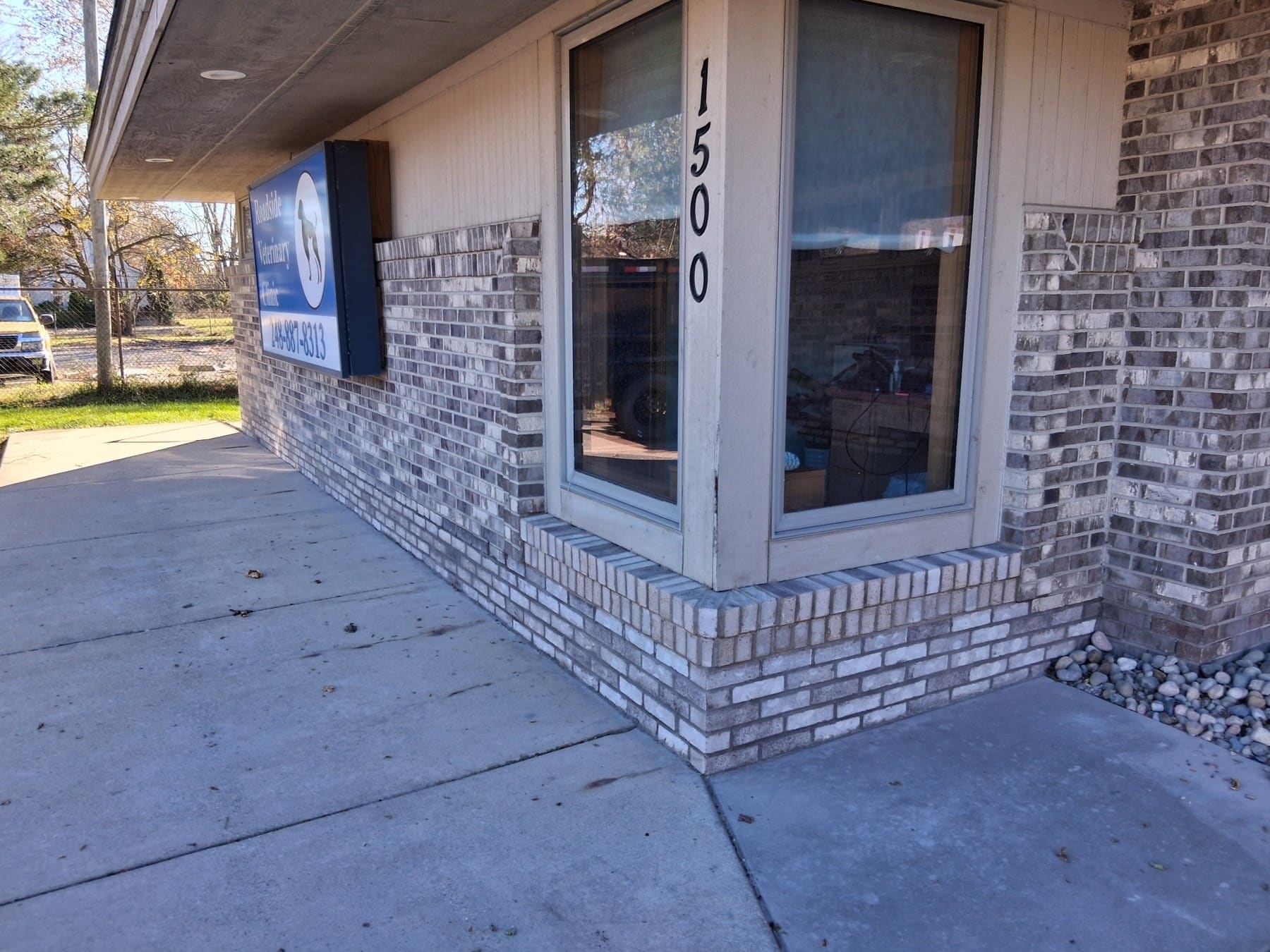 Storefront exterior at 1500 with brick facade and large windows on a sidewalk
